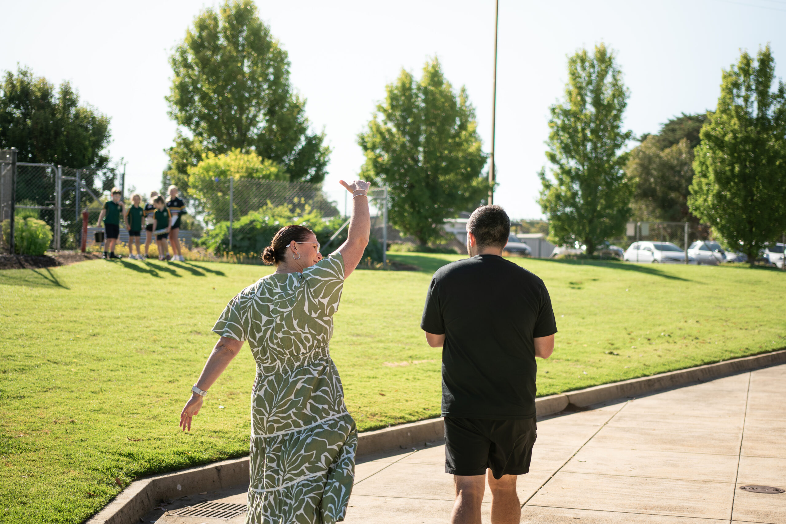 Photographer walking through school grounds with principal