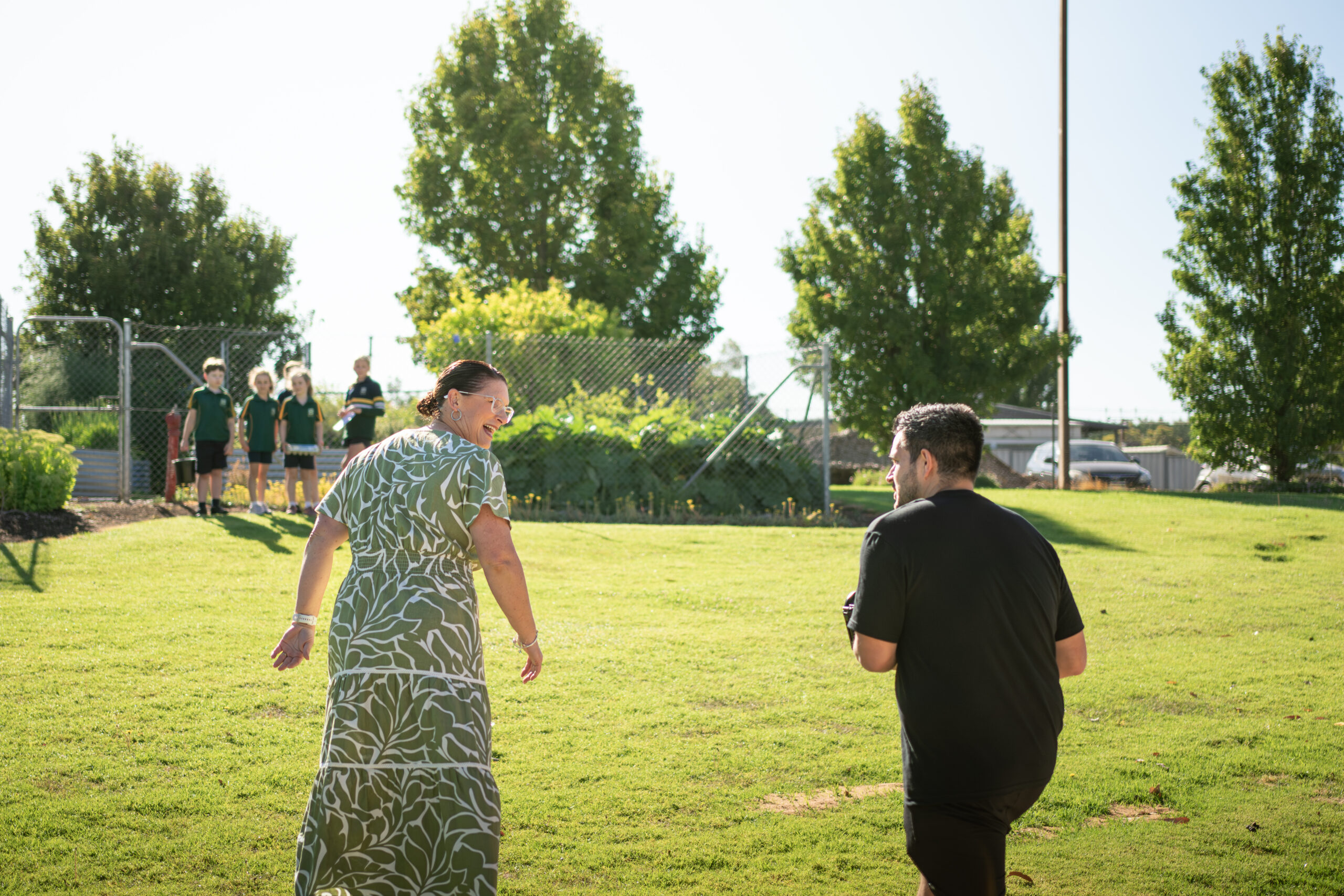 Photographer walking through school grounds with principal